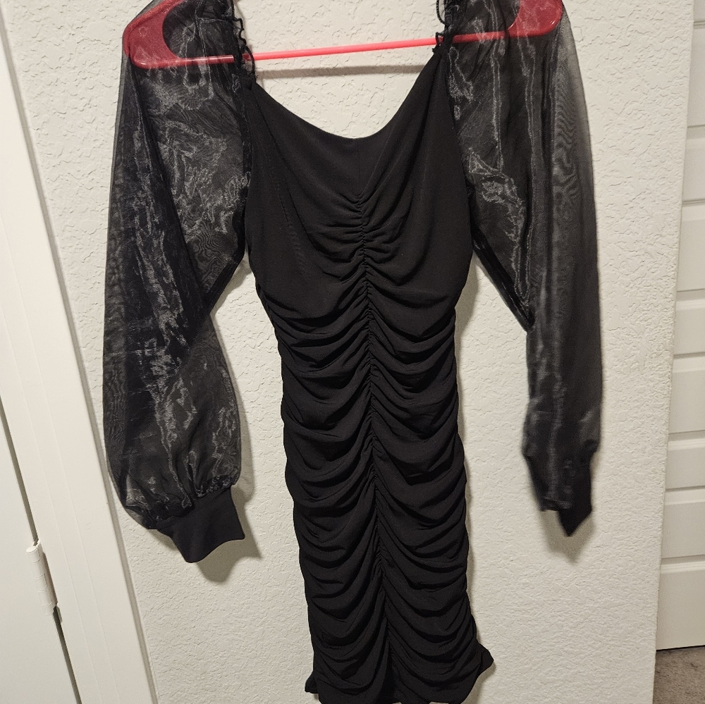 A short long sleeve black dress